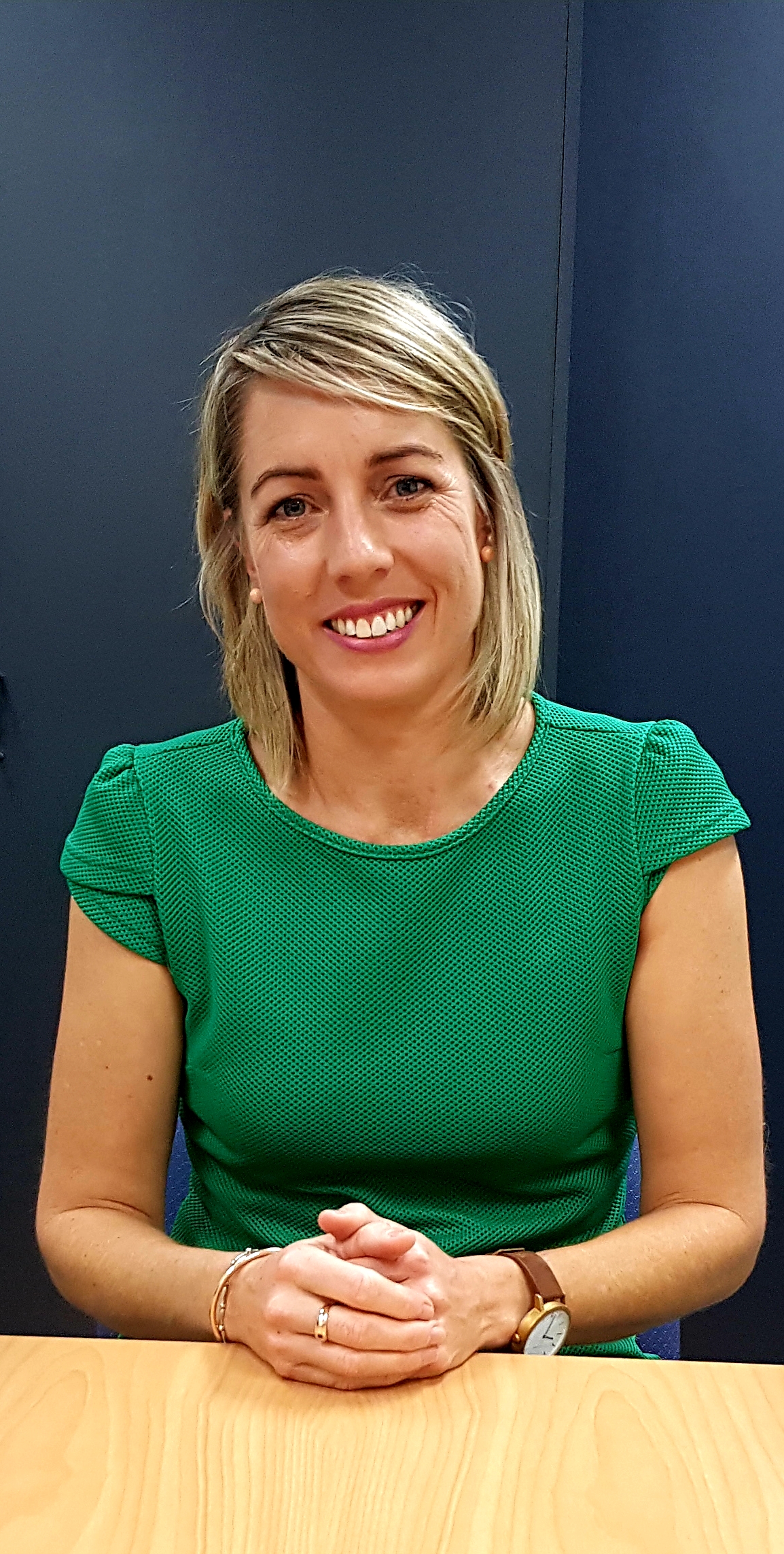Clare Morgan, a woman with blonde hair, wearing a green top