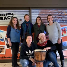 Belinda Adams and a group of people from the Bang the Drum group, with a drum in the foreground