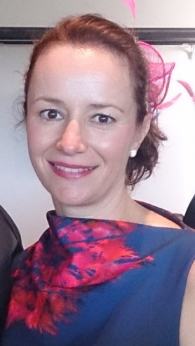 Profile image of Brooke Wadsworth, a woman with blonde hair tied back with pink fascinator.