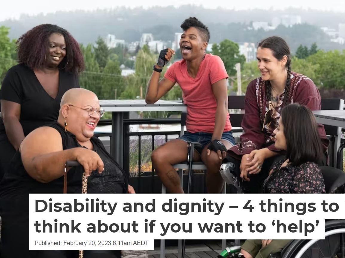 An image of five people sitting outside, smiling and laughing.