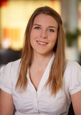 Kelsey Chapman, a woman with straight, blonde hair, wearing a white button up shirt