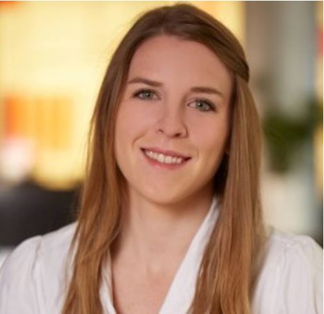 A profile image of Kelsey Chapman, a woman with long, straight blonde hair, wears a white shirt.