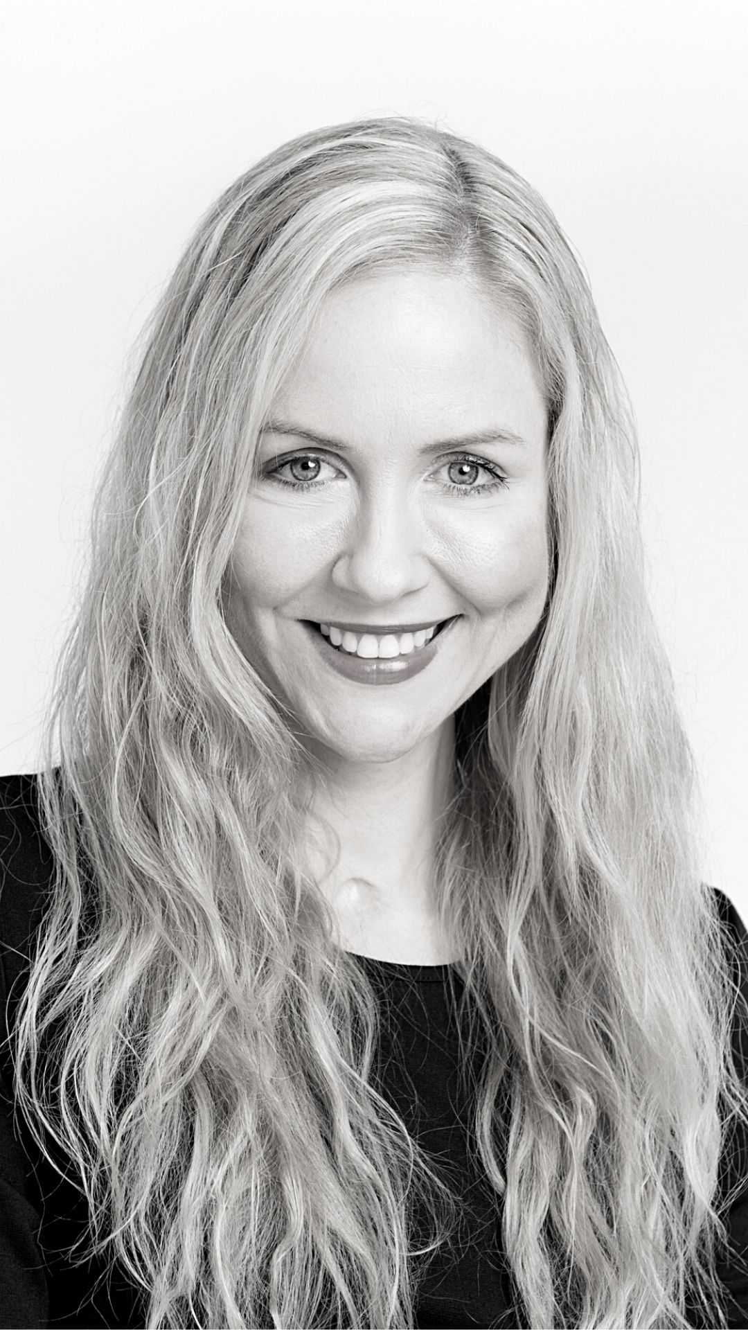 A black-and-white, portrait image of Lisa Cox wearing a black top